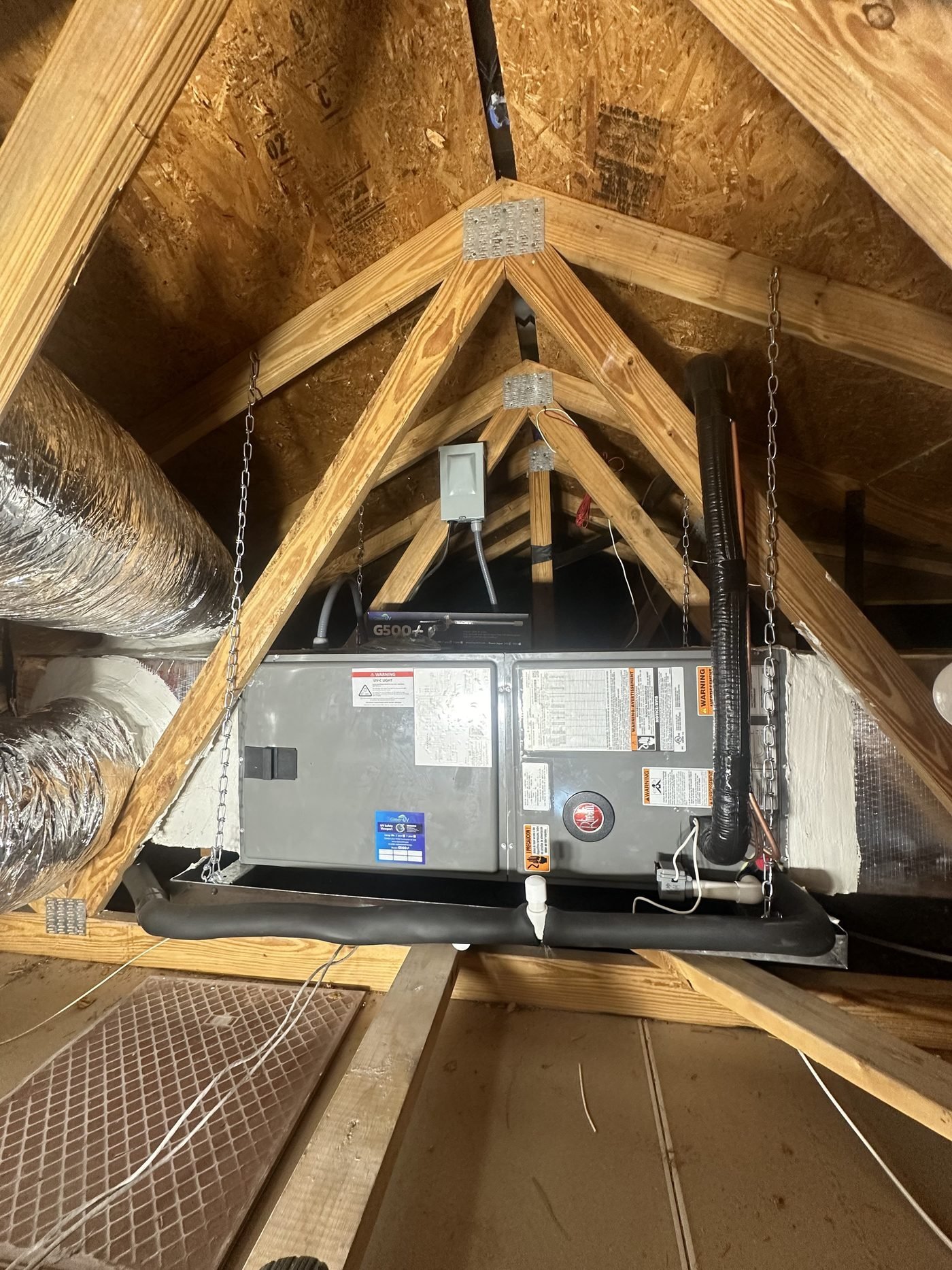 Air handler attic installation suspended from rafters